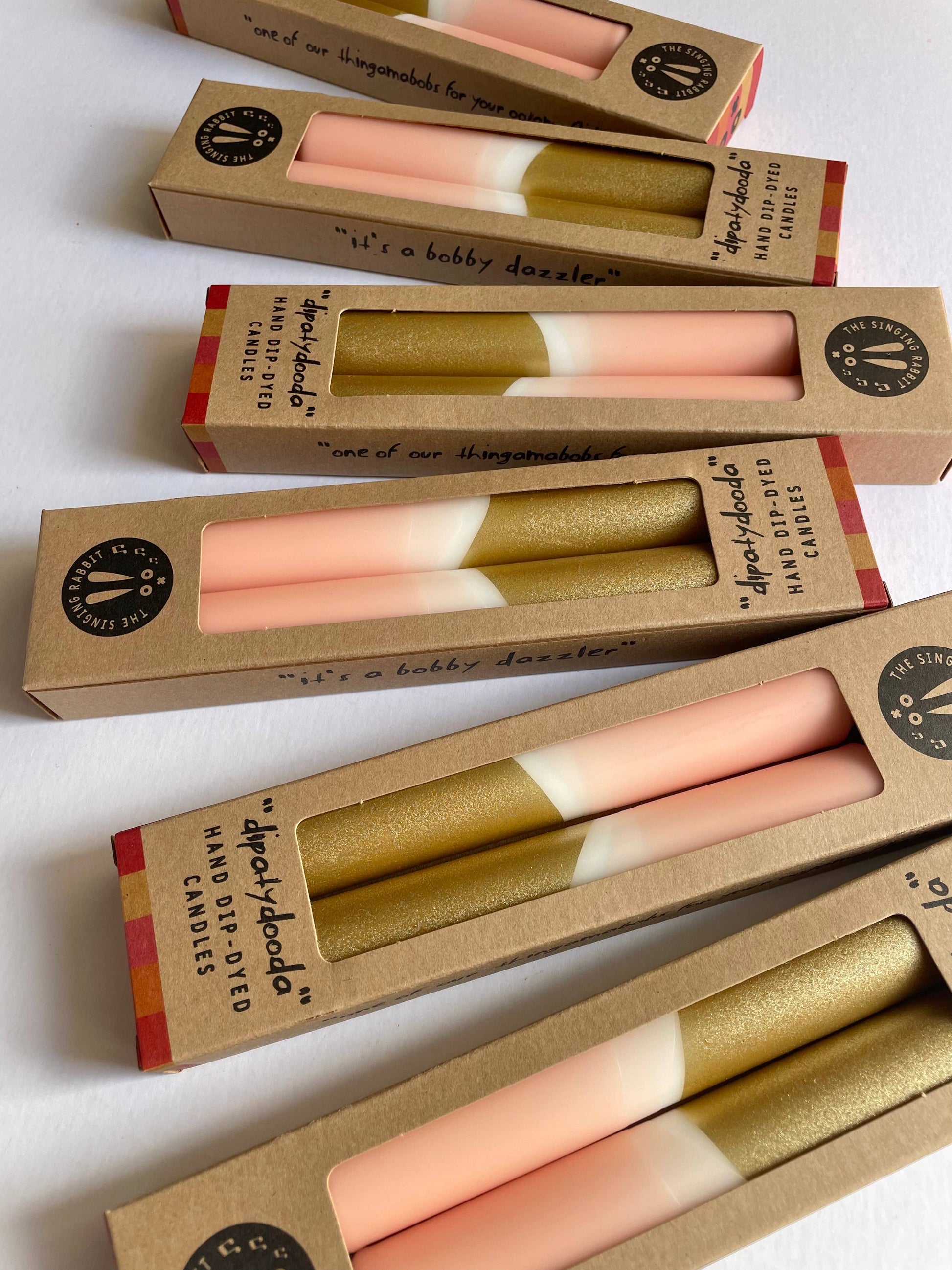 Set of Two dinner candles with a blush pink and gold color scheme packed in eco packaging by The Singing Rabbit for Heart Gallery